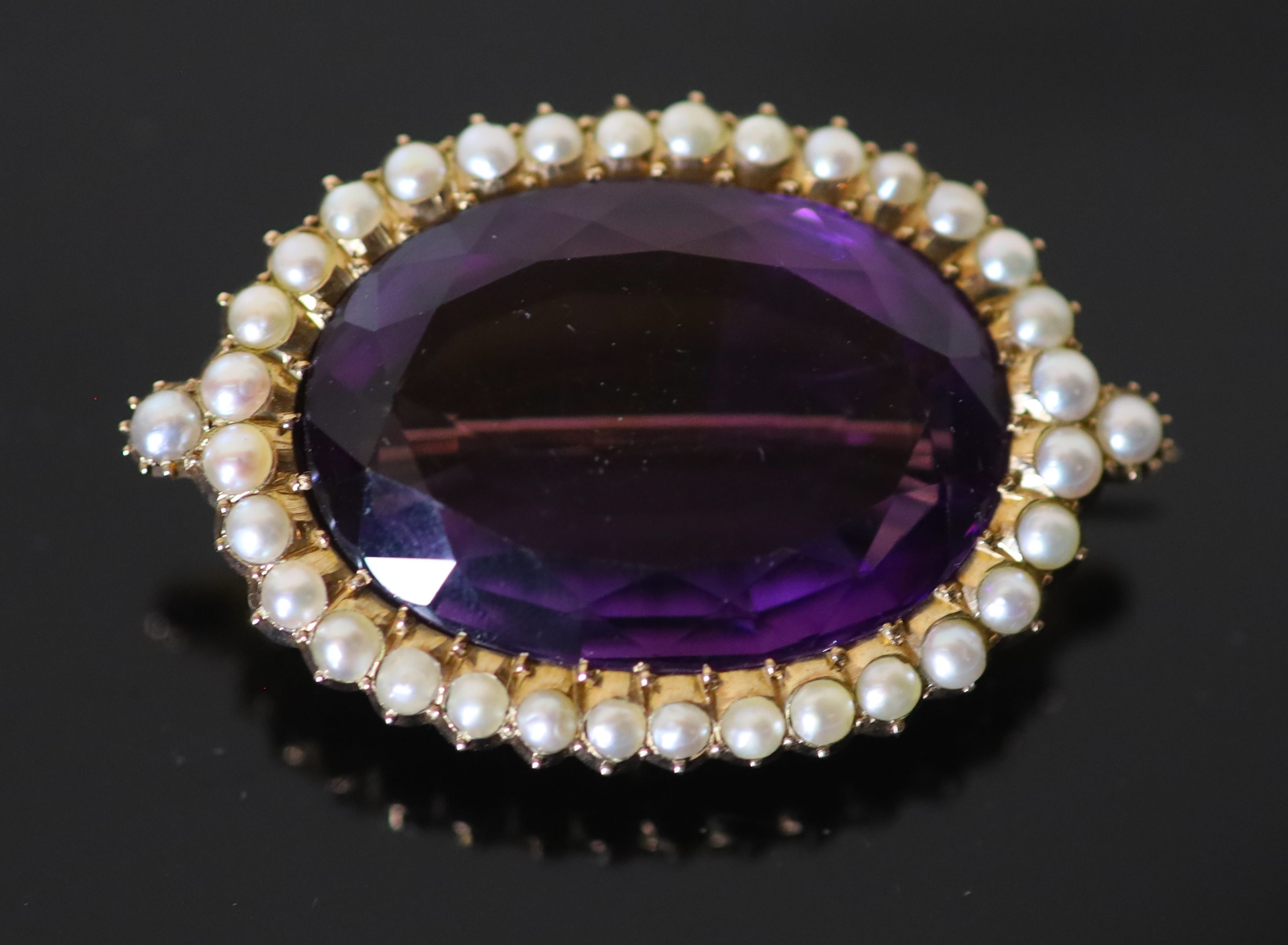 A Victorian style, gold, oval cut amethyst and split pearl cluster set brooch,